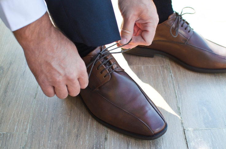 Gentleman preparing his shoes
